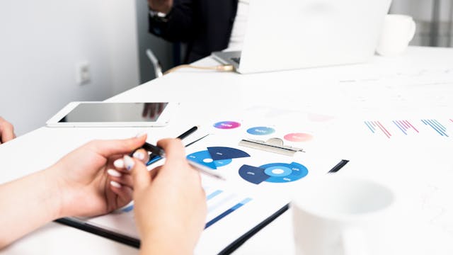 Illustrative image Person Holding Black Pen Writing on White Paper used in Accordemy®'s training on Business Succession Planning