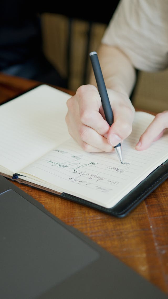 Illustrative image A Person Writing on White Paper used in Accordemy®'s training on Mindfulness in the Workplace