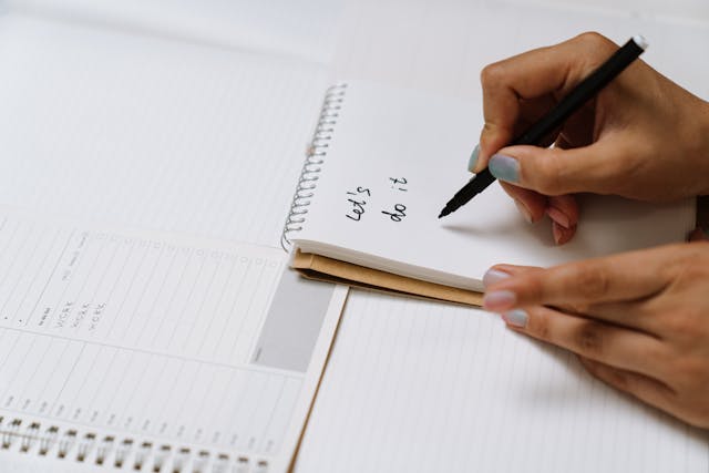 Illustrative image Person Holding White Pen and White Paper used in Accordemy®'s training on Mindfulness in the Workplace