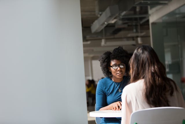 Illustrative image Woman Wearing Blue Top Beside Table used in Accordemy®'s training on Effective Workplace Counselling