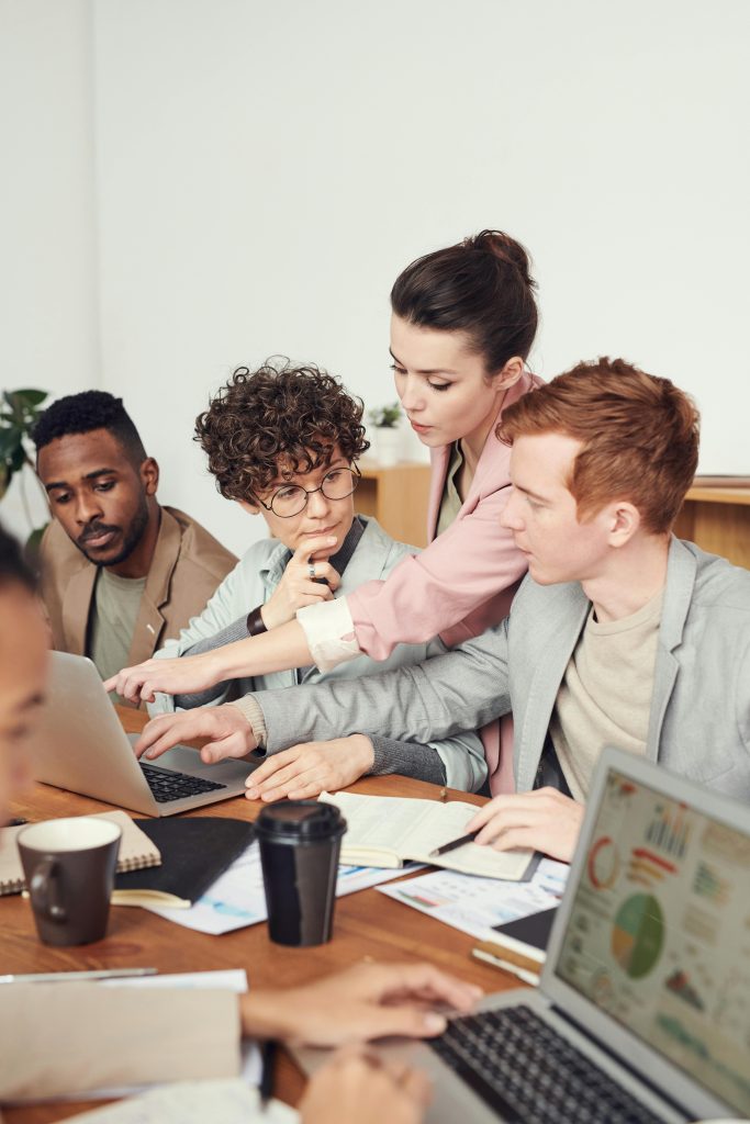 Illustrative image of Photo Of People Sitting Beside Table
 used in Accordemy®'s training on Internal Communications Strategy.
