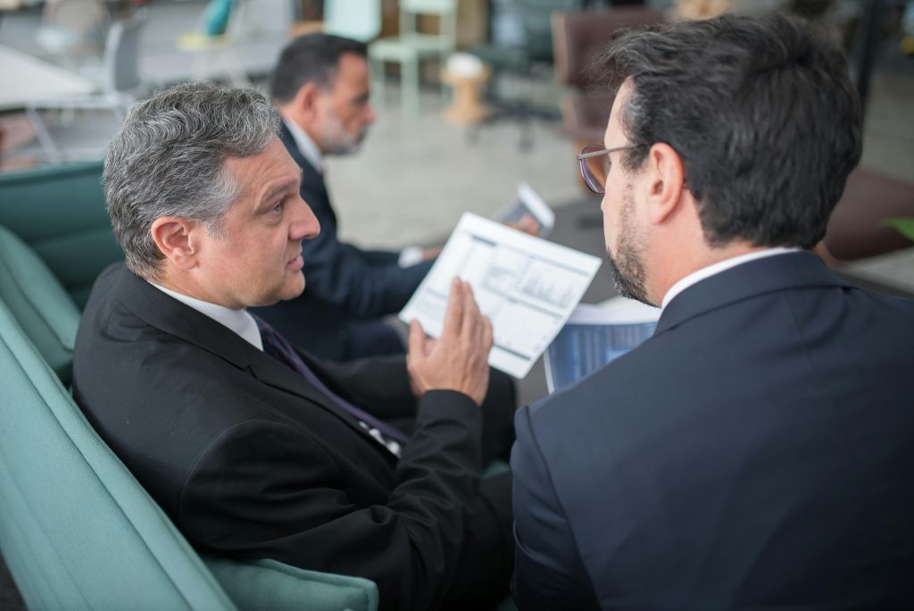  Illustrative image of Men Sitting on Sofa Having a Discussion  used in Accordemy®'s training on Non-Verbal Communication for Executives