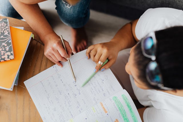 Illustrative image Overhead Shot of Teacher Teaching a Student used in Accordemy®'s training on Performance Quality Improvement