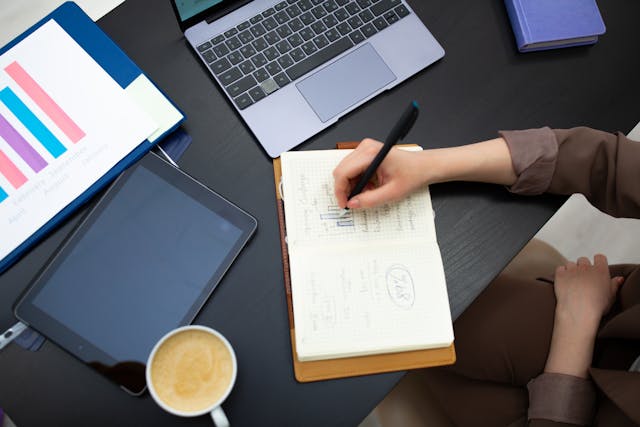 Illustrative image A Person Writing on the Notebook used in Accordemy®'s training on TNA and Training Implementation