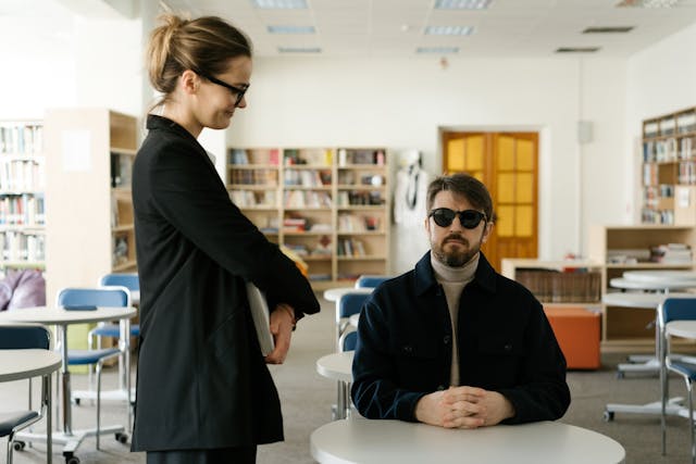 Illustrative image Woman in Black Coat Standing Beside White Table used in Accordemy®'s training on Human Resource Management