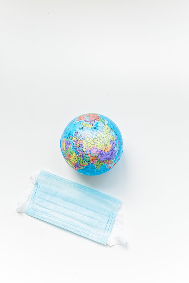 Illustrative image Globe and a Face Mask on White Surface used in Accordemy®'s training on Universal Safety Practices