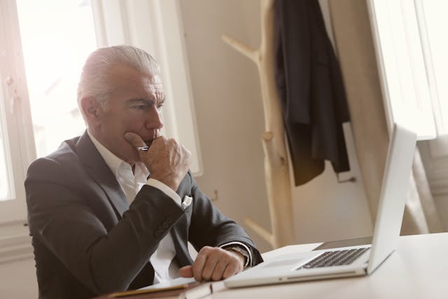 Illustrative image of A Man in Black Suit Leaning on White Table
 used in Accordemy®'s training on Access Management