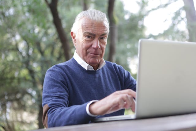 Illustrative image of A Man in Blue Sweater Typing on Computer Laptop
 used in Accordemy®'s training on Access Management