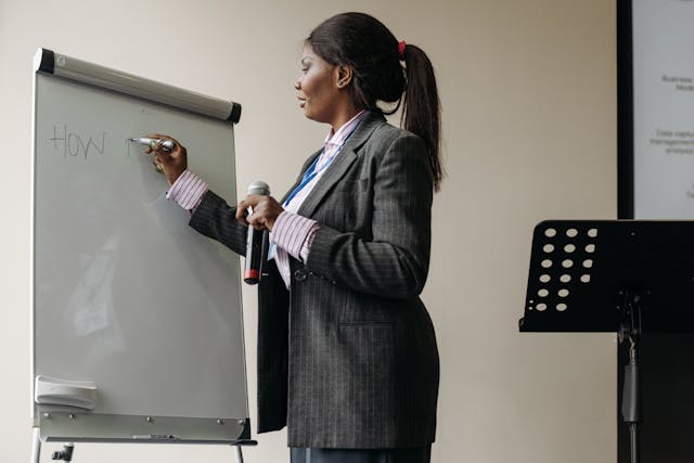 Illustrative imageA Businesswoman Writing on Whiteboard used in Accordemy®'s training on SBM for Training Programs