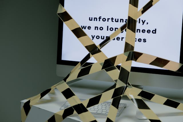 Illustrative image Computer tied with a black and yellow tape   used in Accordemy®'s training on Employee Termination Processes