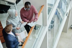 Illustrative image of People Standing Near the Glass Fence used in Accordemy®'s training on Building High-Performance Teams.
