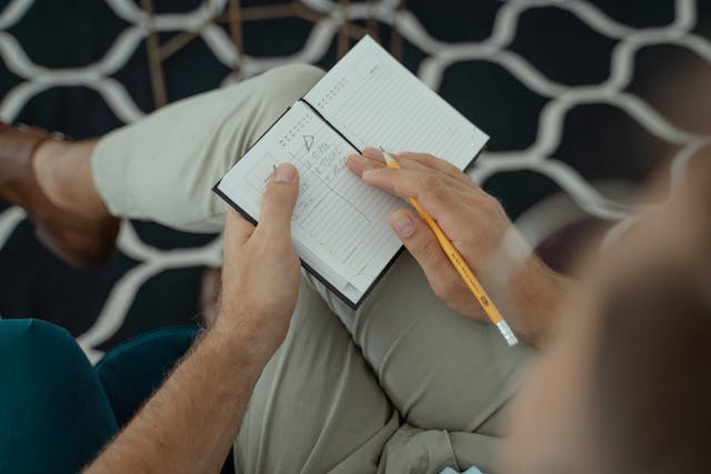 Illustrative image A Person Writing on a Notebook
used in Accordemy®'s training on Personal Development Planning