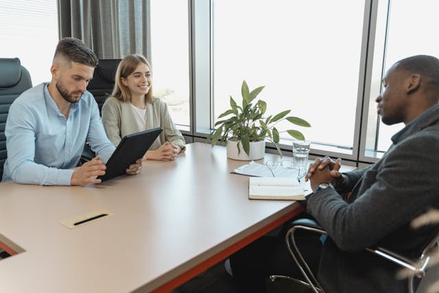 Illustrative image Man in Blue Long Sleeve Shirt Holding a Black Tablet used in Accordemy®'s training on Employee Onboarding