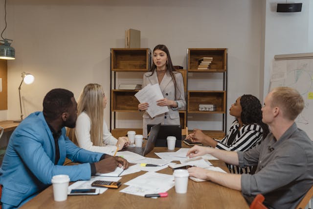 Illustrative image Woman in Gray Blazer Doing a Report used in Accordemy®'s training on ToT for Competency Based Skill Training