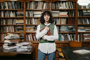 Illustrative image of A Woman Wearing a Vest over a Dress Shirt Holding a Book used in Accordemy®'s training on Cultural Intelligence for Leaders