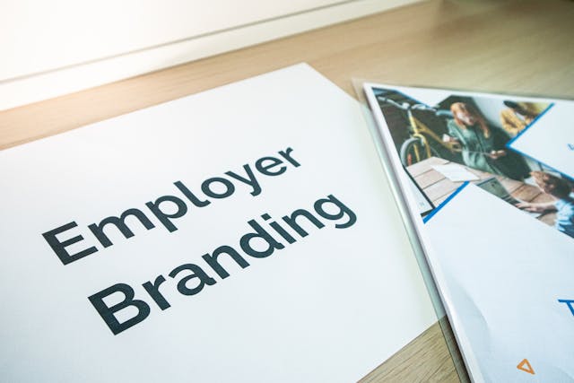 Illustrative image Door Plaque and Magazine Lying on Table used in Accordemy®'s training on Employer Branding Strategy