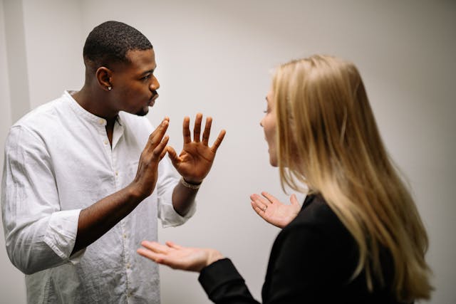 Illustrative image Man in White Dress Shirt Holding Womans Face used in Accordemy®'s training on Managing Workplace Harassment