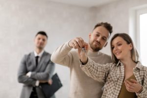 Illustrative image A Couple Holding Their Keys used in Accordemy®'s training on Land Acquisition and Real Estate Planning