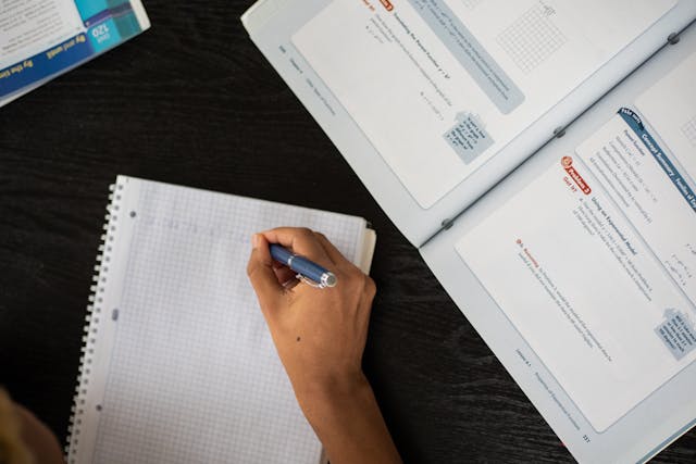 Illustrative image Crop black person writing in copybook used in Accordemy®'s training on Introduction to Blockchain in Supply Chain