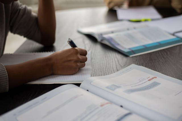 Illustrative image Crop black person writing in workbook while studying used in Accordemy®'s training on Introduction to Blockchain in Supply Chain