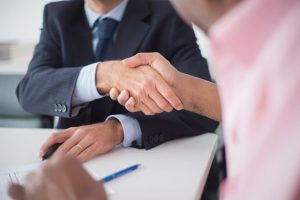 Illustrative image Close-up of Shaking Hands Between Men used in Accordemy®'s training on Land Affairs Contract Management