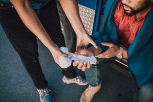 Illustrative image A Person Handing Out a Gauze to a Man Sitting used in Accordemy®'s training on Mental Health First Aid