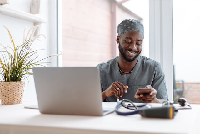 Illustrative image A Man in Scrub Suit Using His Cellphone used in Accordemy®'s training on Telemedicine and Digital Health