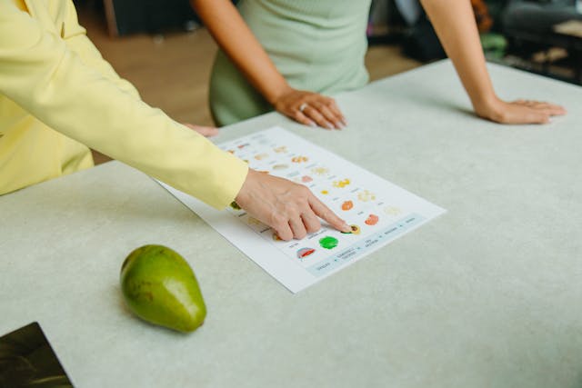 Illustrative image Person in Green Shirt Holding White Printer Paper used in Accordemy®'s training on Managing Competency-based Health Education