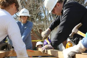 Illustrative image Team of Volunteers Building a House Frame used in Accordemy®'s training on Refugee and Displacement Issues