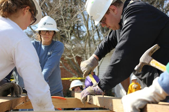 Illustrative image Team of Volunteers Building a House Frame used in Accordemy®'s training on Refugee and Displacement Issues