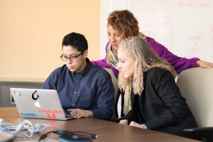 Illustrative image Man in Blue Dress Shirt Using Laptop used in Accordemy®'s training on Communication and Program Development Management