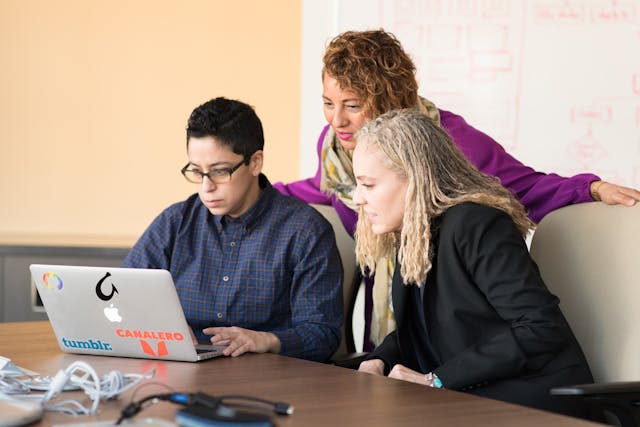 Illustrative image Man in Blue Dress Shirt Using Laptop used in Accordemy®'s training on Communication and Program Development Management