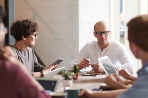 Illustrative image Photo of Man Sitting in Front of People used in Accordemy®'s training on Corporate Behavior
