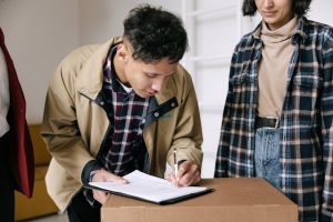 Illustrative image Man in Brown Jacket Signing Papers used in Accordemy®'s training on Process Documentation and Standardization