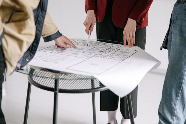 Illustrative image Woman Pointing at Blueprint used in Accordemy®'s training on Business Writing Skills for relief and development managers