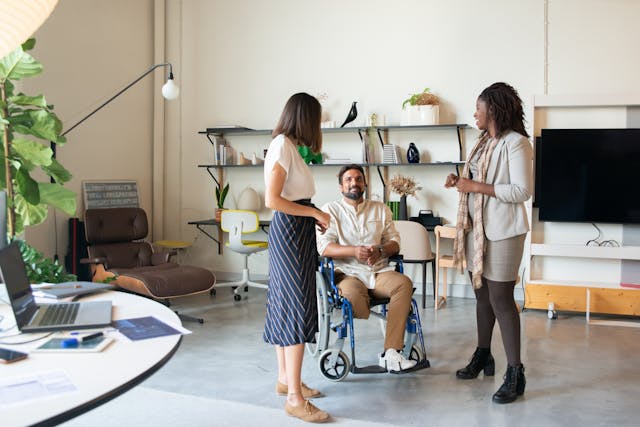 Illustrative image A Team Having a Discussion at the Office used in Accordemy®'s training on Disability mainstreaming in projects/programs