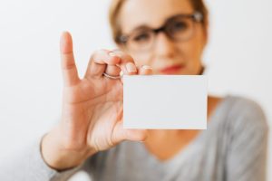 Illustrative image A Woman Holding a Blank Card used in Accordemy®'s training on Professional Image and Personal Branding