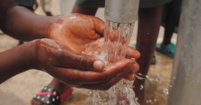 Illustrative image Close-up Of A Child's Hands Catching Water used in Accordemy®'s training on Sustainable Livelihoods in Post-Disaster Recovery