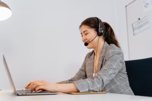Illustrative image A Woman Typing on a Laptop used in Accordemy®'s training on Handling Difficult Conversations