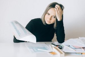Illustrative image Woman in Black Long Sleeves Holding White Paper used in Accordemy®'s training on Proactive Problem Solving and Decision Making