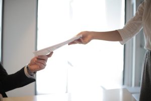 Illustrative image Job Applicant Passing Her Documents used in Accordemy®'s training on Supervising Others