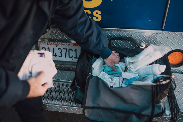 Illustrative image Person Getting Medical Supplies from a Bag used in Accordemy®'s training on Emergency Medical Response in Disaster Situations