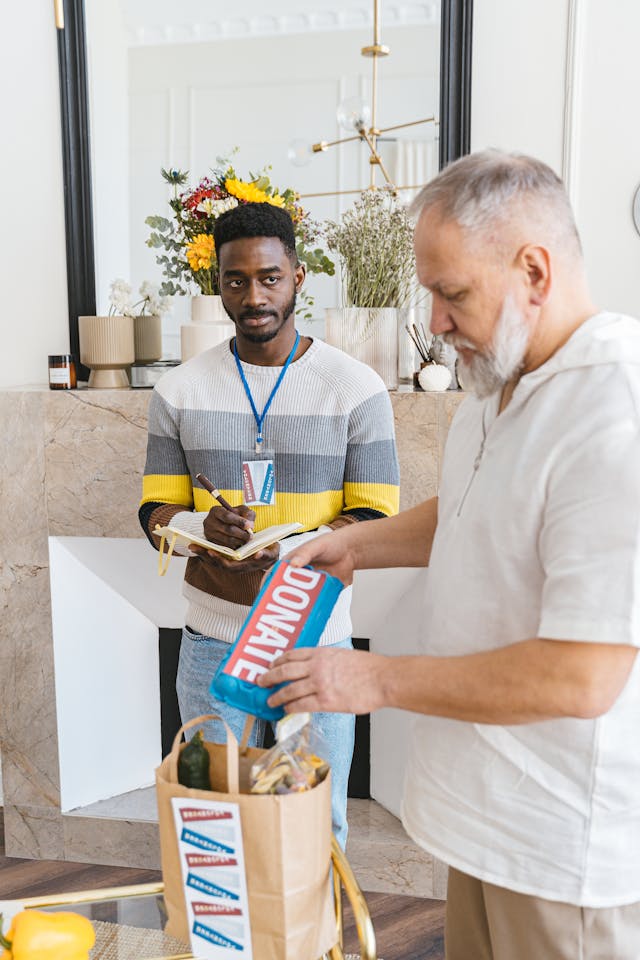 Illustrative image A Man Making a Donation Placed in Paper Bag used in Accordemy®'s training on Grant Writing and Fundraising in Humanitarian Settings
