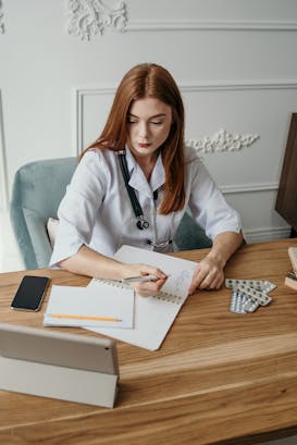 Illustrative image Photo Of Woman Writing On A Desk used in Accordemy®'s training on How to engage private sector in PPP's for health