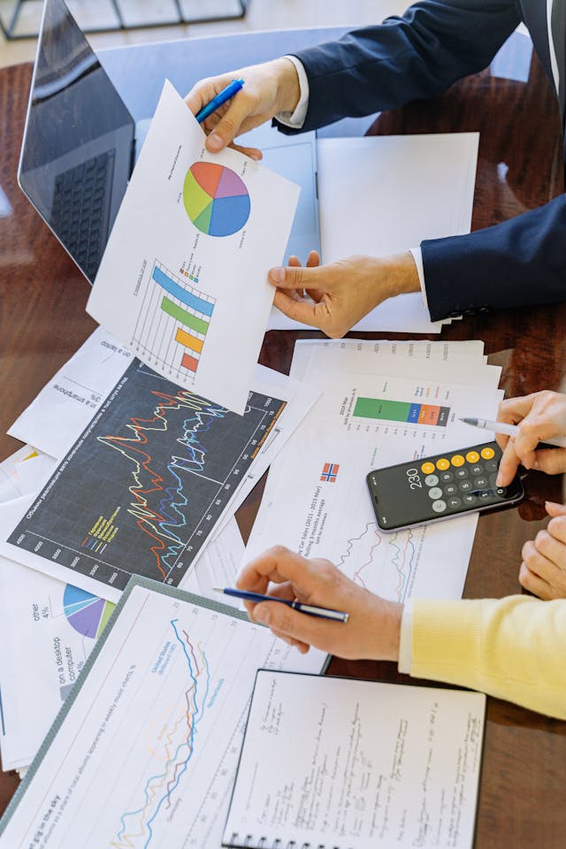 Illustrative image Person Holding Black Smartphone and White Printer Paper used in Accordemy®'s training on Review of Financial Accounting and Detecting Fraud